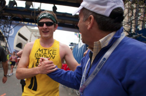 Shaking hands with the Tufts University President Larry Bacow after finishing the Boston Marathon in 2010.