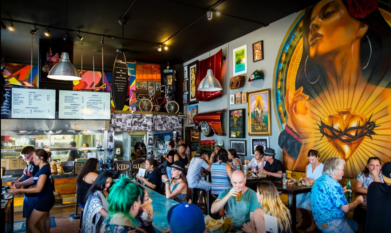 Patrons dine inside ¡Salud Tacos!, a " hip, casual Mexican eatery" located in San Diego, CA.