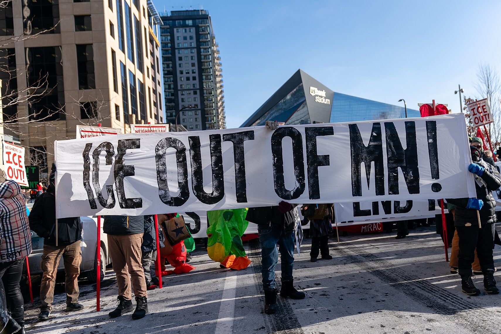 protest in minnesota with sign that says "ICE OUT OF MN"